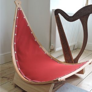 Photo of Hang-In-Out's rocking chair beside a harp.