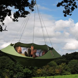 Hang-In-Out's leaf green Lullio Cacoon hanging from a tree with two ladies relaxing on board